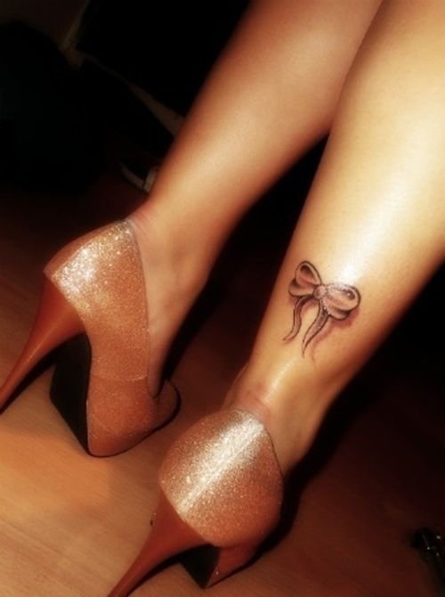 Bow Tattoo On Right Back Leg