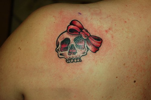 Skull and Bow Tattoo On Left Back Shoulder