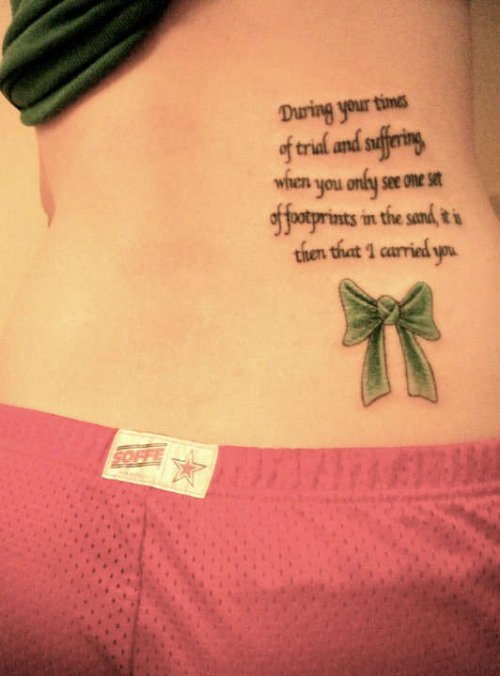 Quote and Green Bow Tattoo On Lowerback