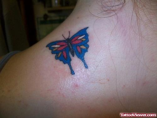 Red And Blue Ink Butterfly Tattoo On Back