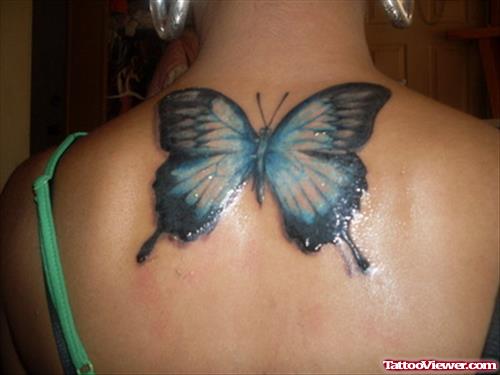 Blue Ink Butterfly Tattoo On Girl Upperback