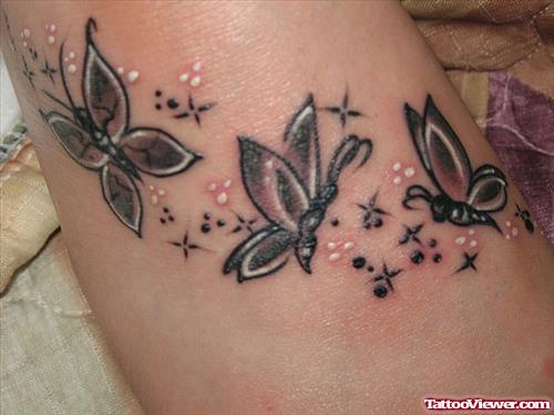 Grey Ink Flying Butterflies Tattoo On Foot