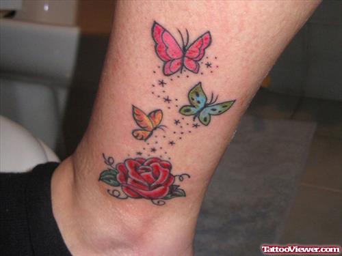 Rose Flower And Colored Butterflies Tattoo On Leg