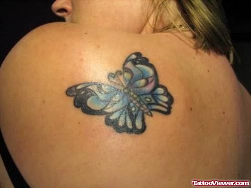 Attractive Blue Ink Butterfly Tattoo On Girl Left Back Shoulder