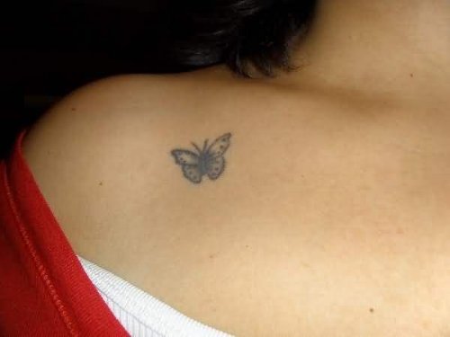 Tiny Simple grey Ink Butterfly Tattoo On Collar Bone