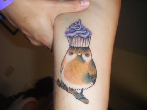 Cake On Sparrow Head Tattoo On Arm