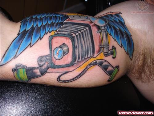 Winged Camera Tattoo On Muscle