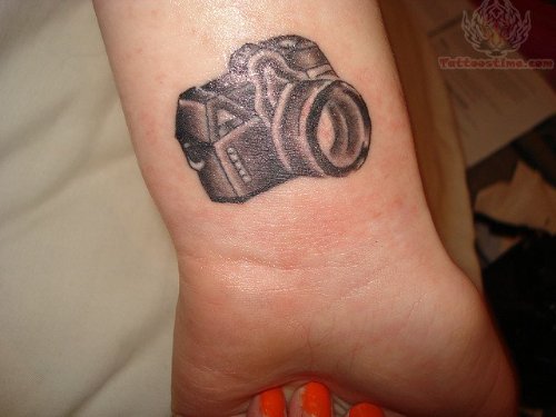 Small Black Camera Tattoo On Wrist