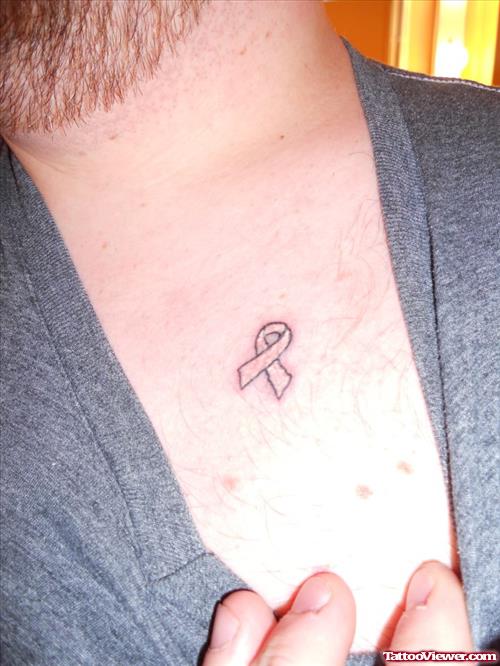 Small Ribbon Cancer Tattoo On Collarbone