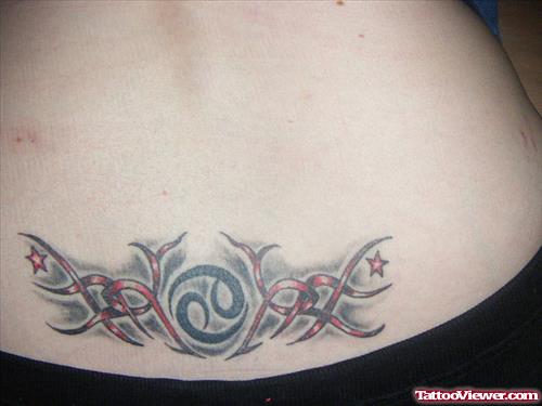 Red Ink Tribal And Cancer Tattoo On Lowerback