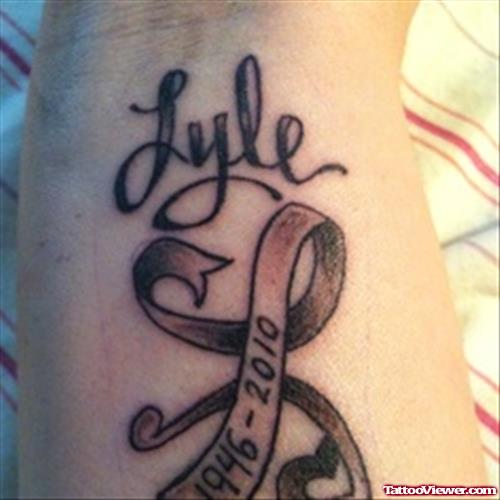 Lyle Grey Ink Ribbon Cancer Tattoo On Forearm