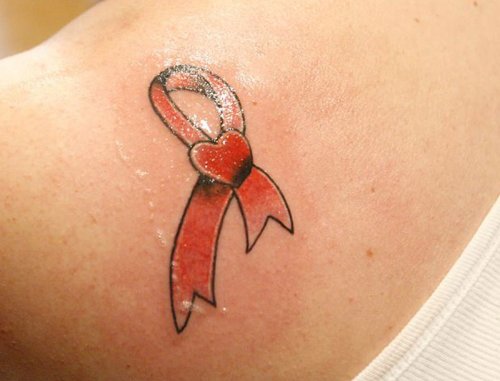 Tiny Red Heart And Cancer Sign Tattoo