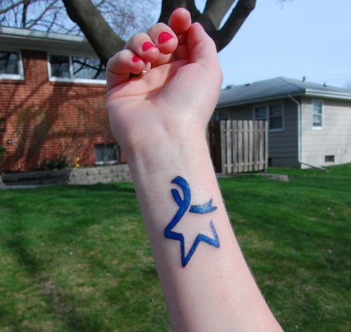 Blue Ink Star And Ribbon Cancer Tattoo On Right Forearm