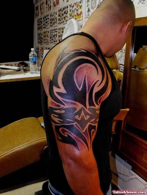 Black Ink Tribal Capricorn Tattoo On Half Sleeve