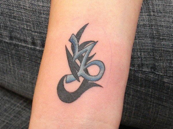 Black And Blue Tribal Capricorn Tattoo On Aem