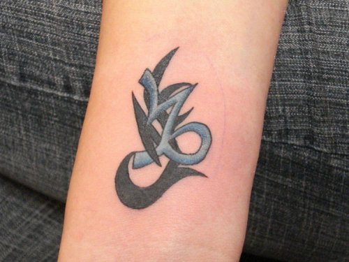 Black And Blue Tribal Capricorn Tattoo On Aem