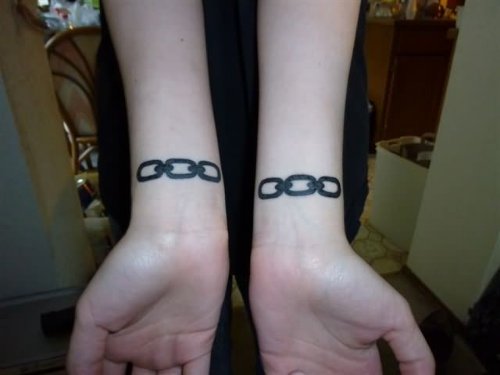 Attractive Black Ink Chain Tattoos On Wrists