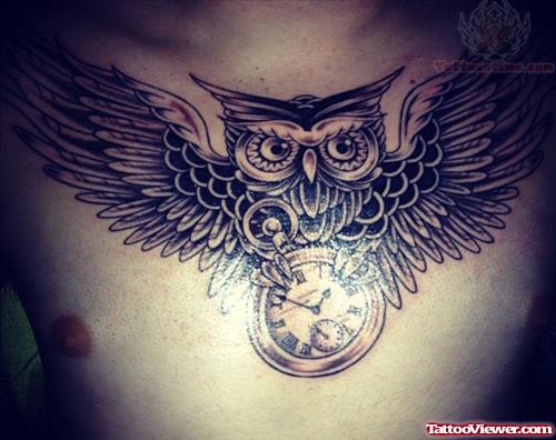 Flying Owl With Clock In Claws Chest Tattoo