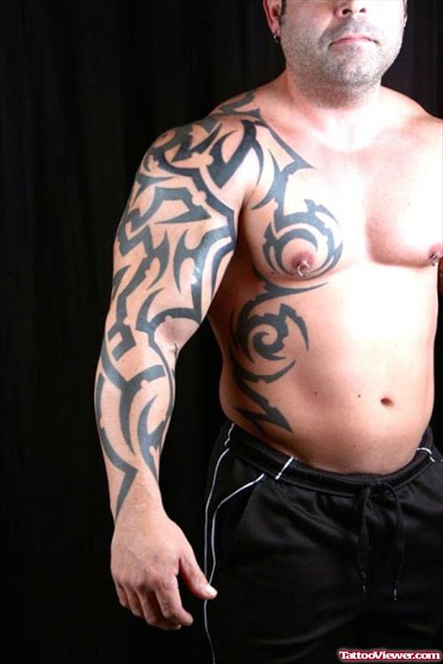 Tribal Tattoo On Man Right Sleeve And Chest Tattoo
