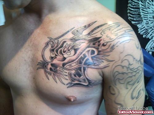 Grey Ink Dragon Head Chest Tattoo
