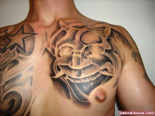 Grey Ink Devil Face Chest Tattoo