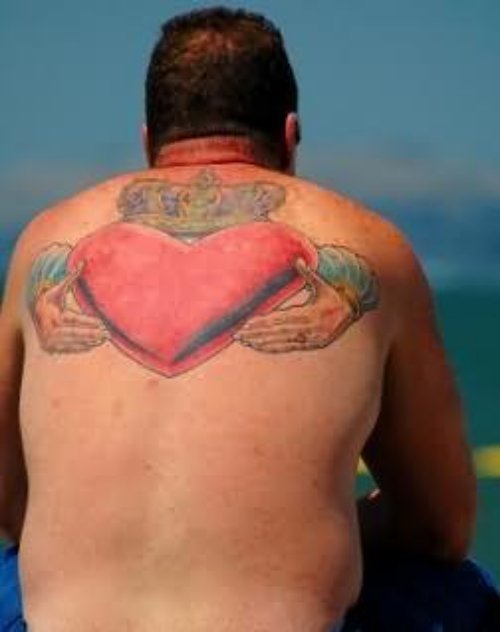 Claddagh Tattoo On Man Upper Back