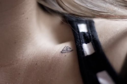 Tiny Ship Tattoo On Collarbone