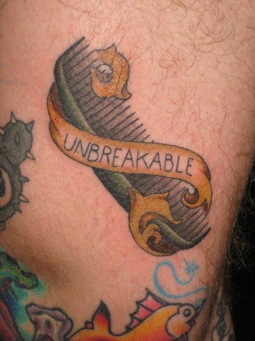 Unbreakable Banner And Comb Tattoo