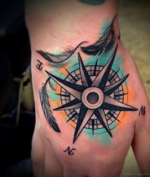 Small Feathers And Compass Tattoo On Hand