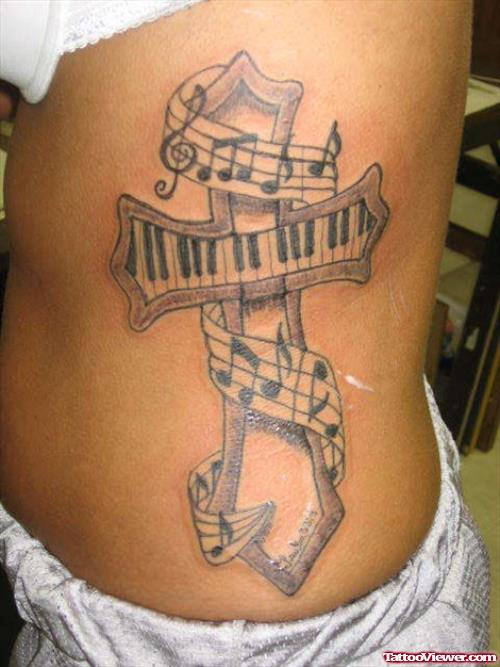 Cross With Piano Keys Tattoo On Side Rib