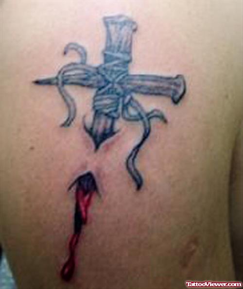 Ripped Skin Cross Tattoo On Right Shoulder