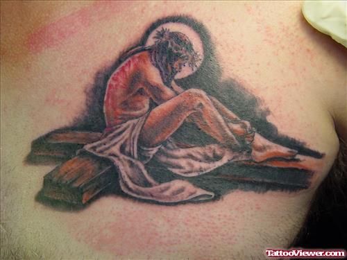 Jesus Sitting On Cross Tattoo On Chest