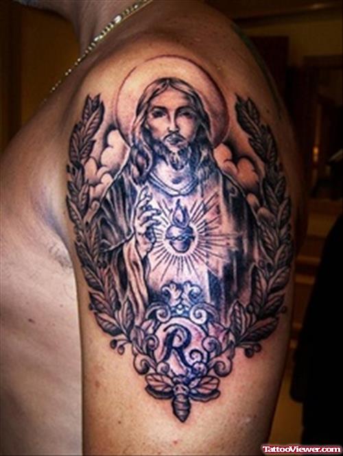 Grey Ink Jesus With Cross Tattoo On Man Left Shoulder