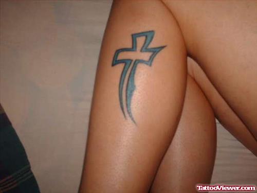 Blue Ink Cross Tattoo On Left Leg