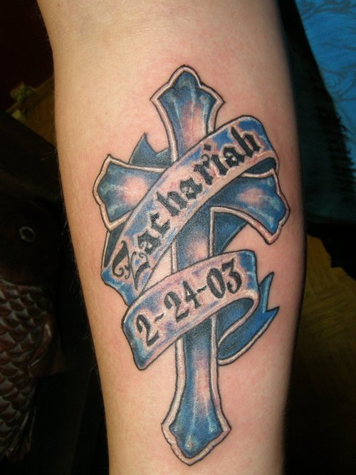 Blue Ink Memorial Cross Tattoo On Arm