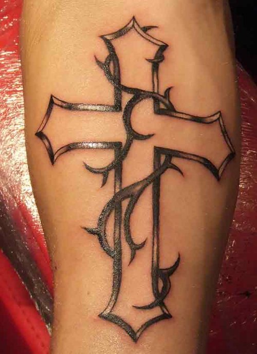 Grey Tribal And Cross Tattoo On Arm
