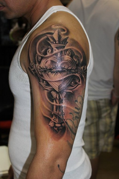 Guy With Sacred Heart And Cross Tattoo On Left Shoulder