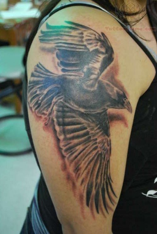Flying Crow Tattoo On Girl Bicep