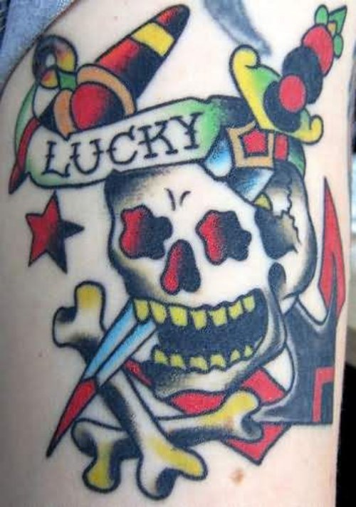 Lucky Banner And Skull With Dagger Tattoo