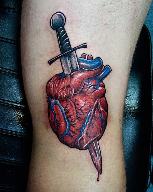 Real Heart With Dagger Tattoo On Bicep