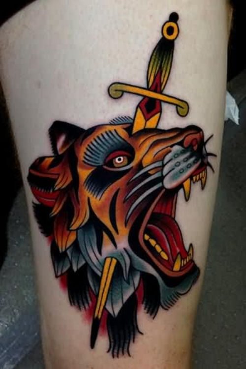 Lion Head With Dagger Tattoo On Leg
