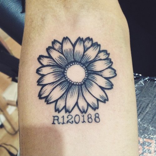 Grey Ink Daisy Flower Tattoo On Arm