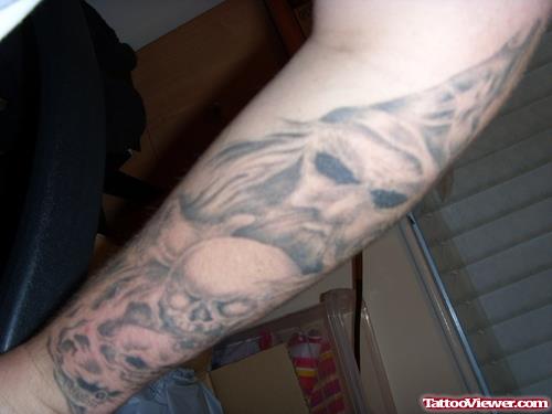 Grey Ink Skulls And Devil Tattoo On Left Sleeve