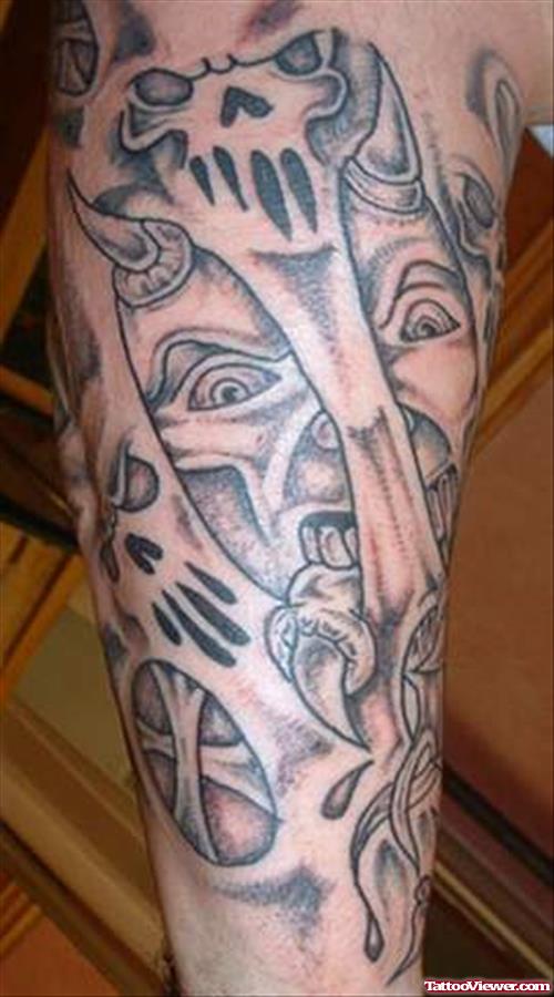 Grey Ink Devil Heads Tattoo On Sleeve