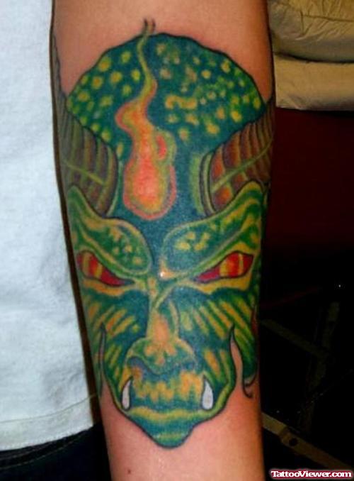 Green Ink Devil Head Tattoo On Forearm