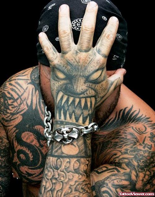 Devil Face Tattoo On Left Hand