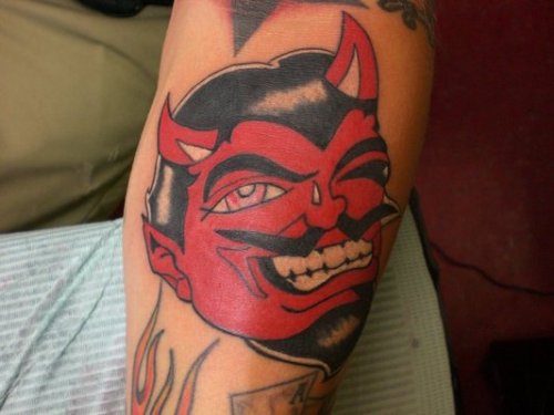 Red Ink Devil Face Tattoo On Arm
