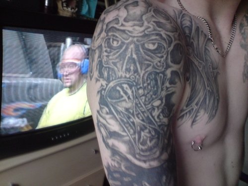 Grey Ink Skull And Hourglass Devil Tattoo