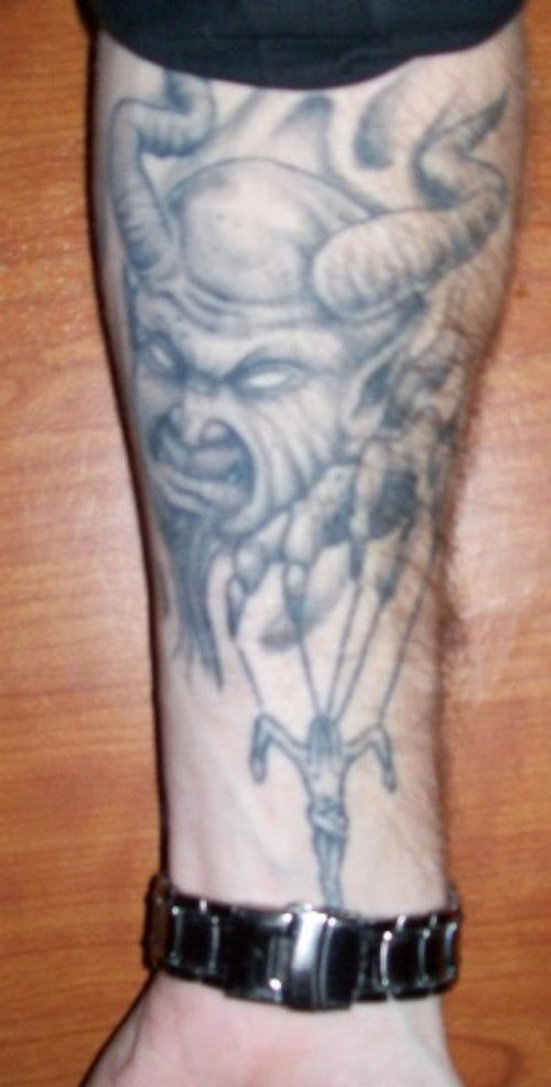Attractive Grey Ink Devil Tattoo On Forearm