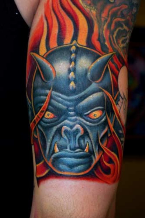 Blue Devil Head In Red Flames Tattoo On Sleeve